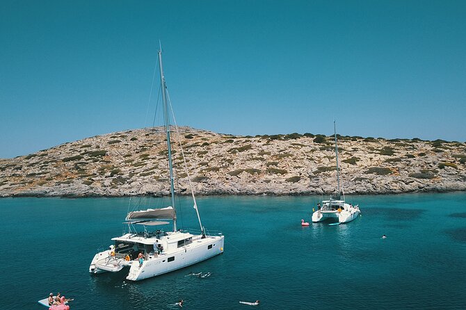 Agios Nikolaos Evening Catamaran Cruise in Mirabello With Dinner - Activities and Amenities Offered