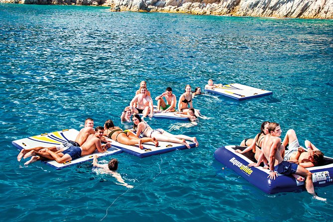 Sailing Along the Costa Brava in a Large Catamaran With a Buffet Barbecue and Bathing Inlet. Drinks Are Included.