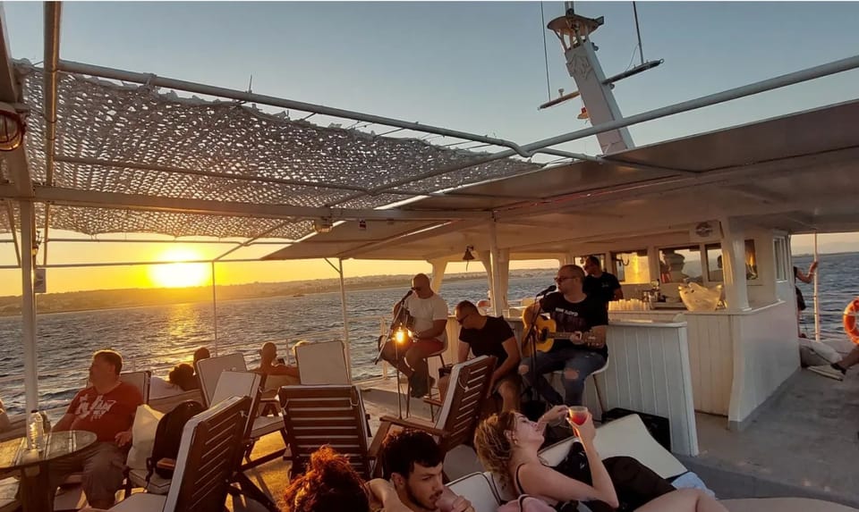 Rhodes: Sunset Cruise With Live Music, Wine & Greek Buffet - Cruise Itinerary and Activities