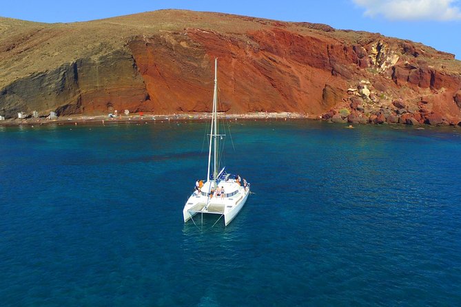 Santorini Full Day Catamaran Private Cruise Incl. Meal, Drinks & Free Transport - Sail Along Santorinis Coastline