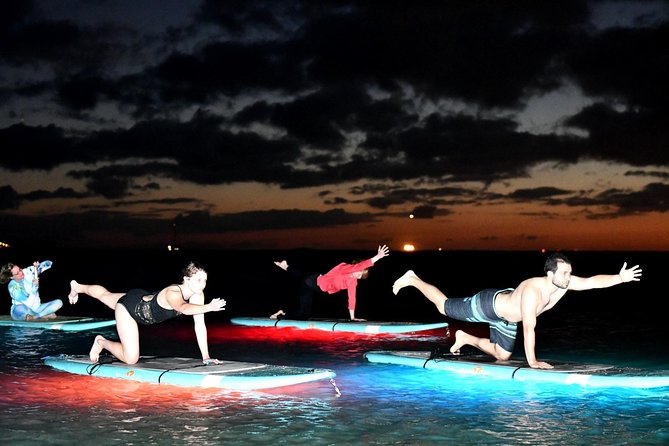 Night SUP Yoga in Honolulu, Hawaii - Practicing Yoga on a Paddleboard