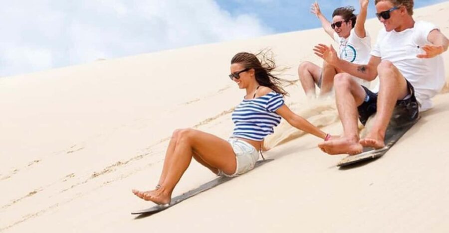 Sunset Desert Camel Ride With Sandboarding and BBQ Dinner