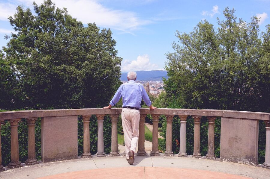 A visitor walking in the Boboli Gardens looking out at Florence