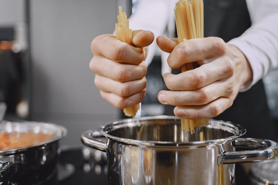 Chef adding fresh pasta to boiling water