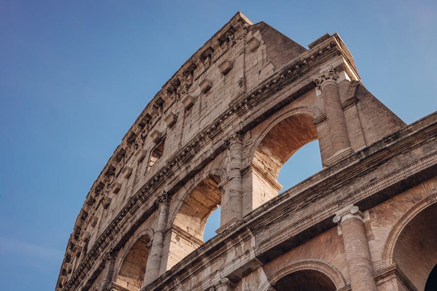 Angled view of the Colosseum under a clear blue sky in Rome