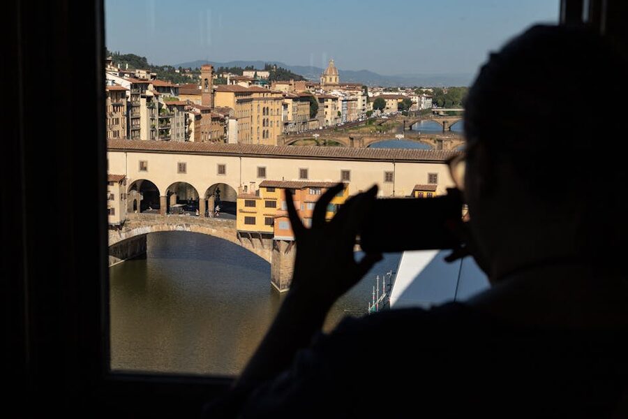 Silhouette photographing Ponte Vecchio in Florence