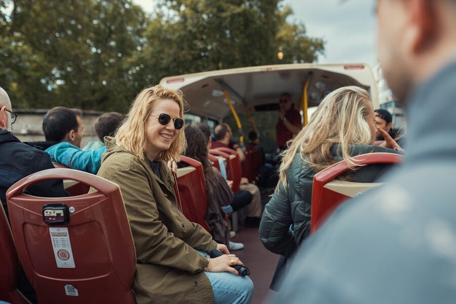 Tour bus passengers enjoying an open-top sightseeing ride