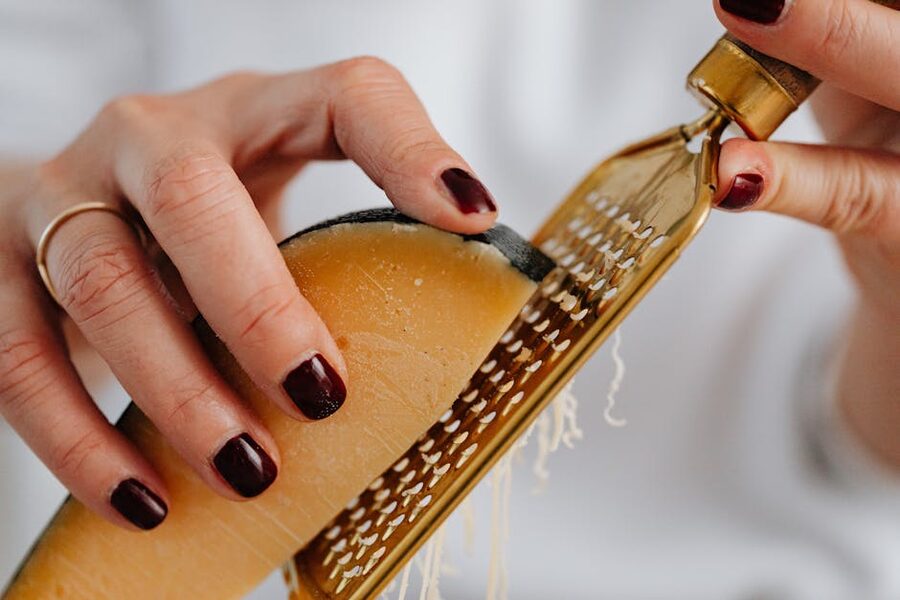 Hands grating fresh parmesan cheese