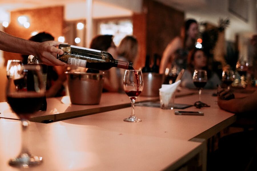 Pouring red wine at an intimate gathering