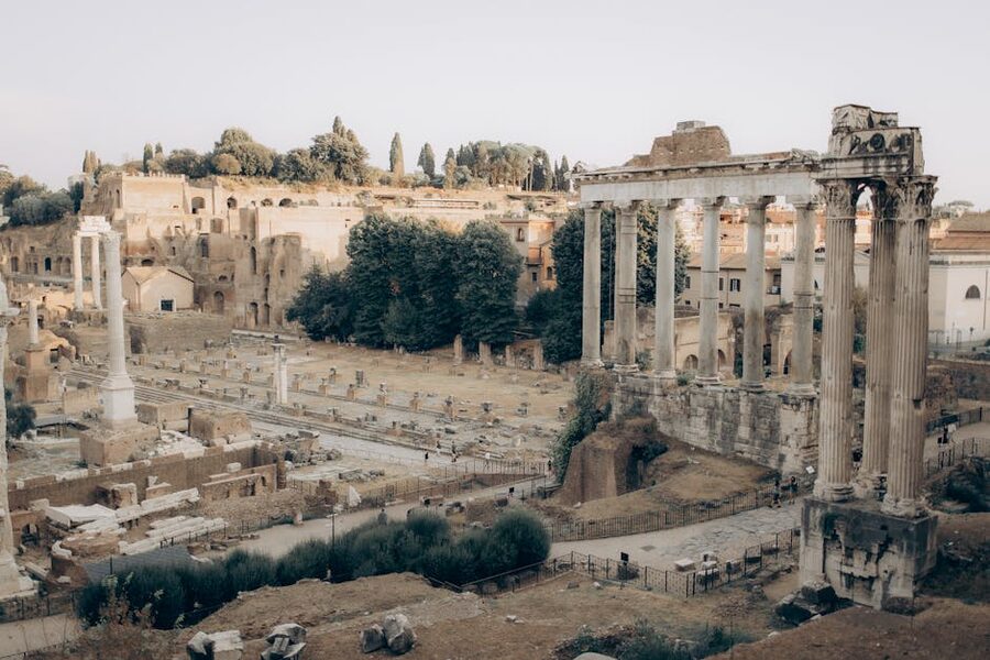 The Roman Forum ruins stretching toward the Colosseum in background