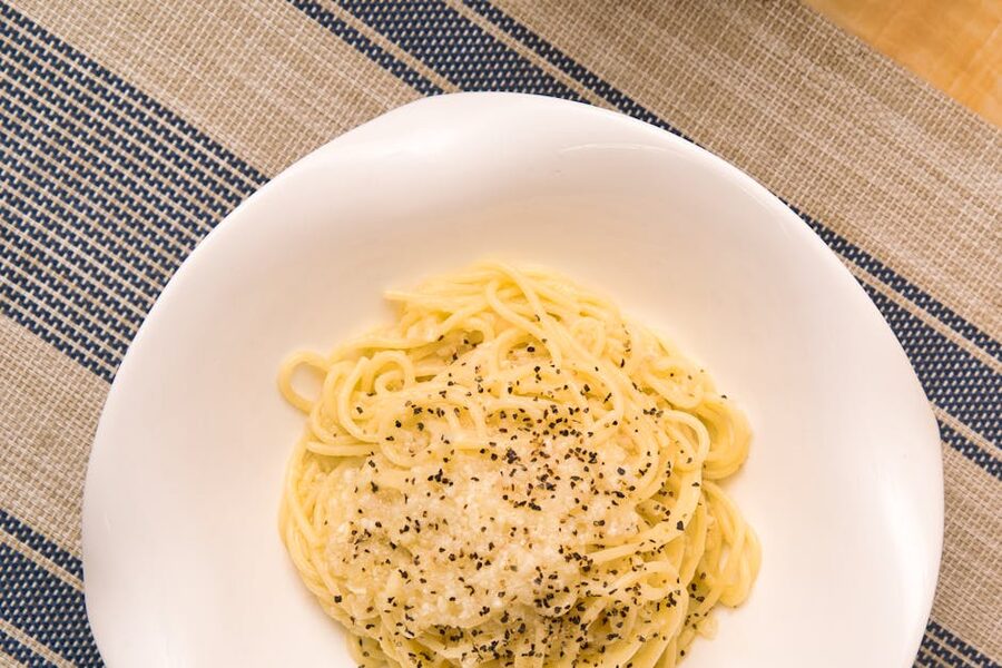 Top view of cacio e pepe pasta with melted cheese