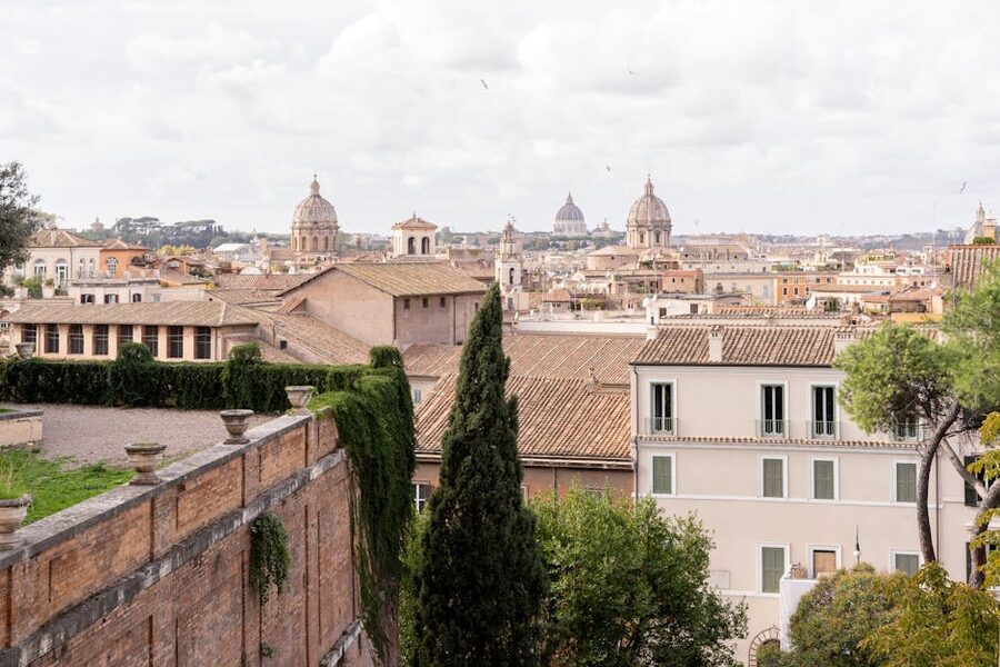 Panoramic cityscape of Rome from a rooftop showing domes and monuments