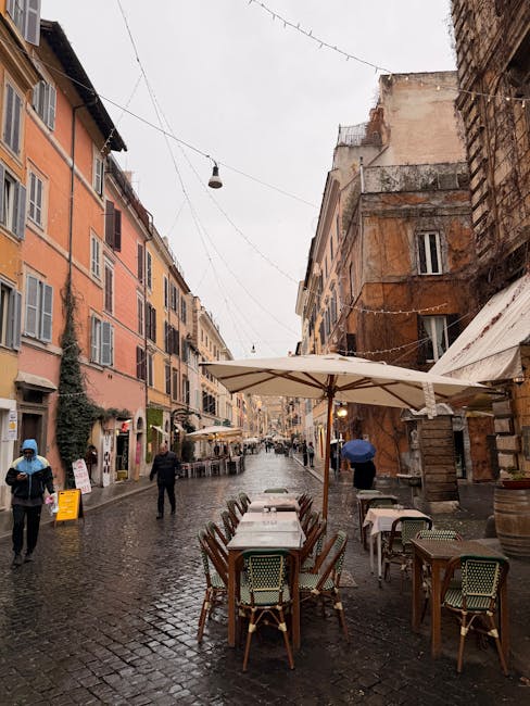 Wet cobblestone street with umbrellas in Rome Trastevere