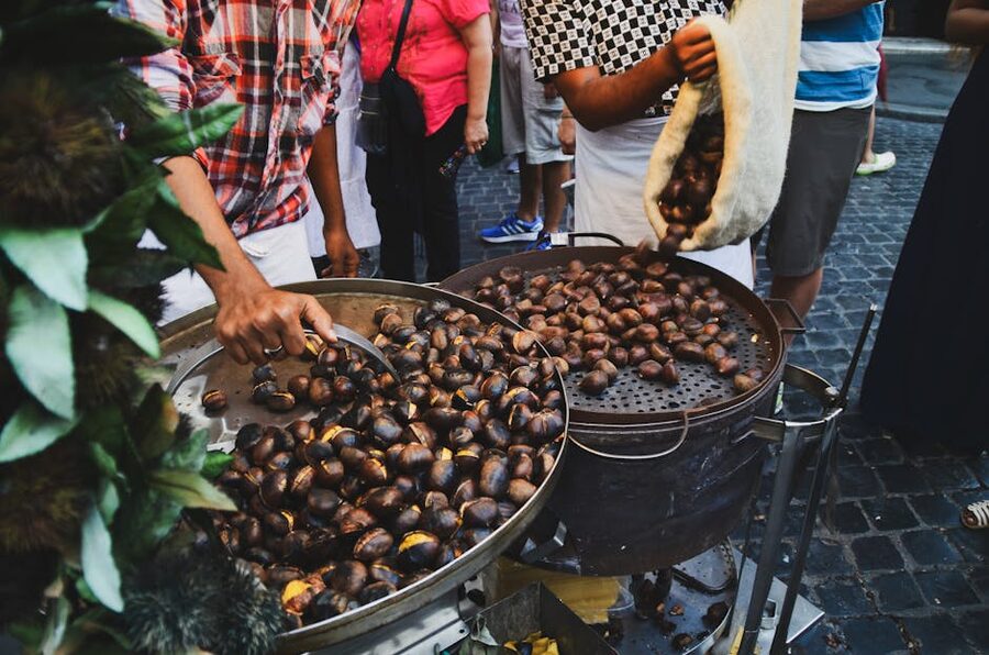 Street vendor roasting chestnuts in a Rome market