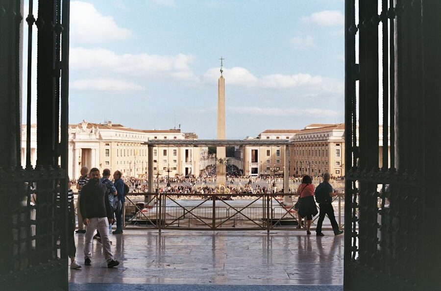 St Peters Square with obelisk and visitors on a bright day