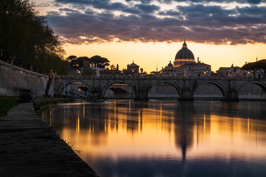 Rome skyline with domes silhouetted against sunset