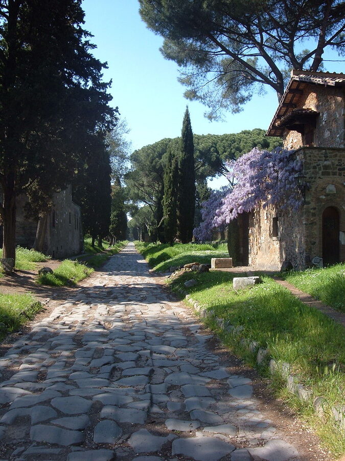 The ancient Via Appia Antica road lined with cypress trees and ruins outside Rome
