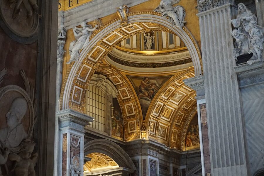 Baroque arches and gilded decorations inside St Peters Basilica