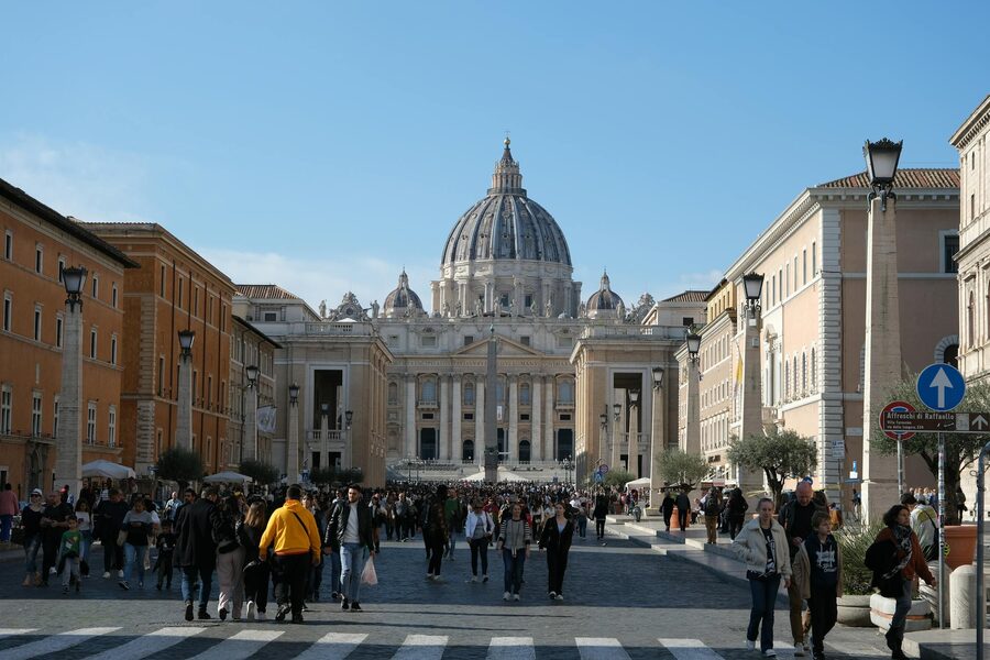 Crowds gathered outside St Peters Basilica in Vatican City on a sunny day