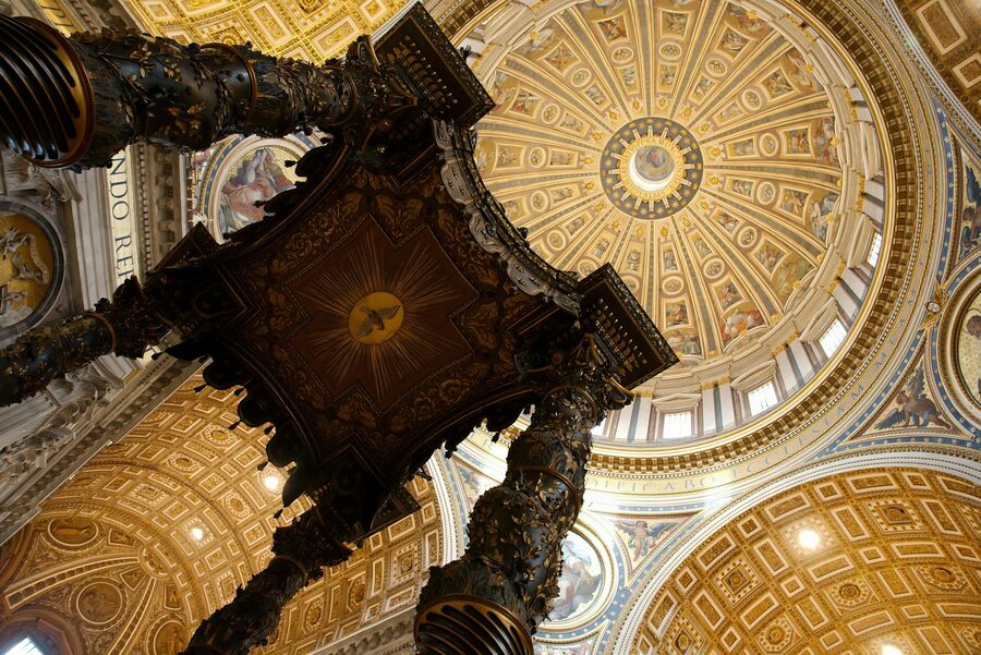 Interior view looking up at the dome of St Peters Basilica
