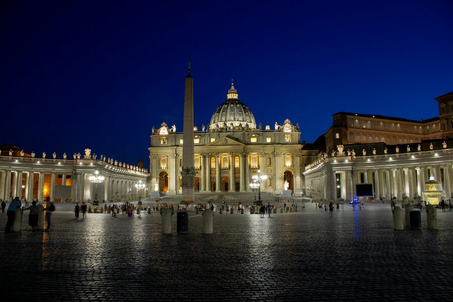 St Peters Basilica illuminated at night against a dark sky