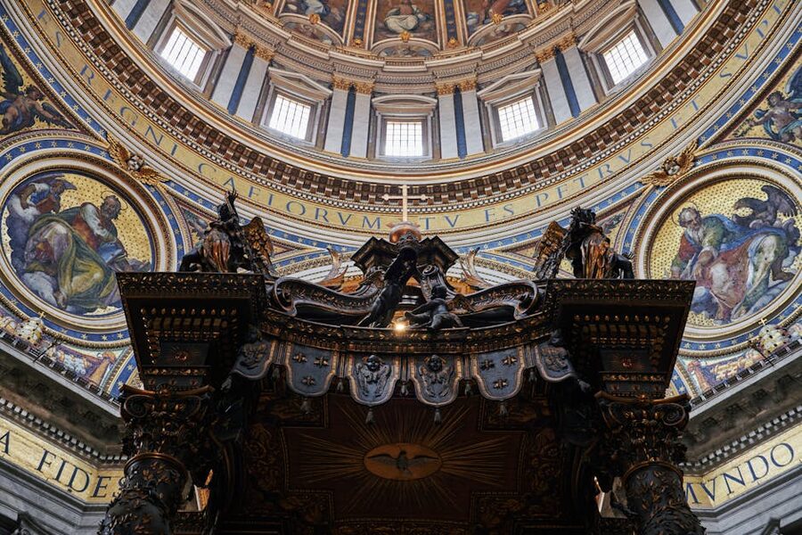 Intricate interior design of St Peters Basilica dome with gold mosaics