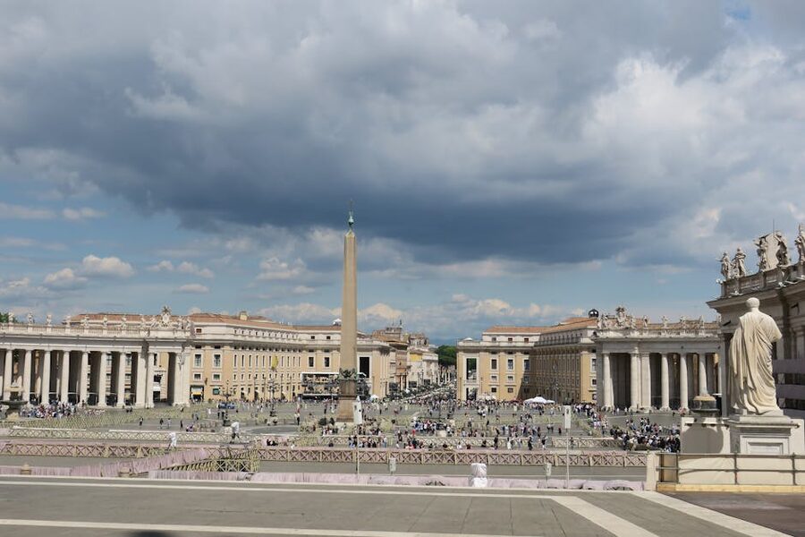 Visitors gathering in St Peters Square with the basilica behind
