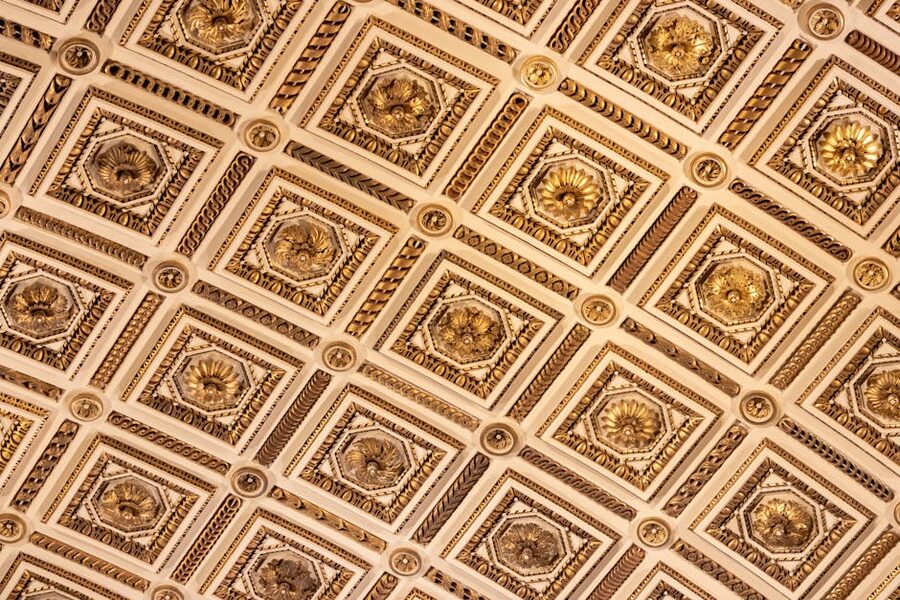 Ornate gold and white ceiling design at the Uffizi Gallery