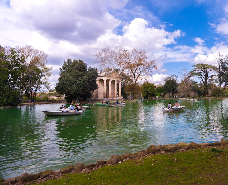 People boating on the lake near Temple of Aesculapius in Villa Borghese