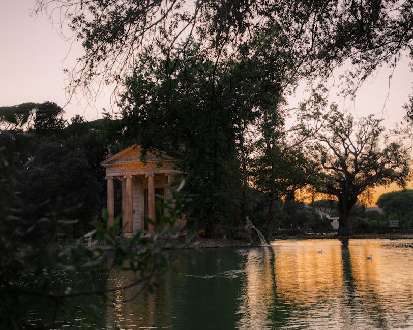 Temple of Aesculapius reflecting in the lake at Villa Borghese gardens