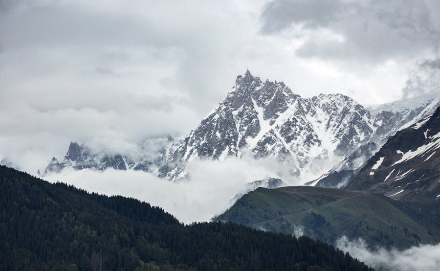 Snow-capped Aiguilles du Midi peaks among clouds, Chamonix