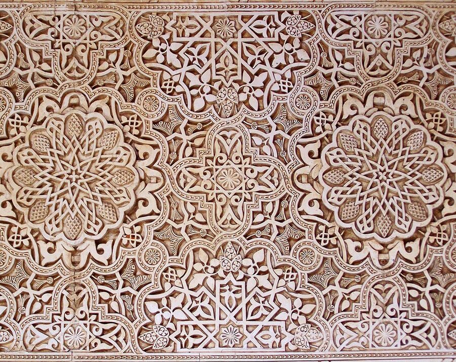 Detail of Arabic geometric pattern carved into stone at the Alhambra