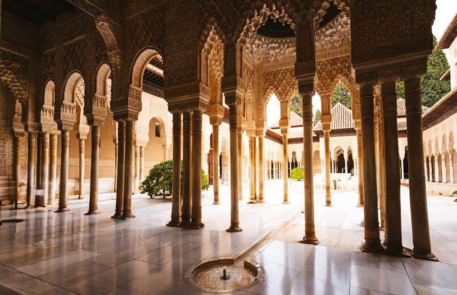 Stuccoed arches and columns inside the Alhambra Nasrid Palaces