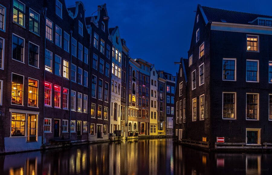 Amsterdam canal at night with reflections