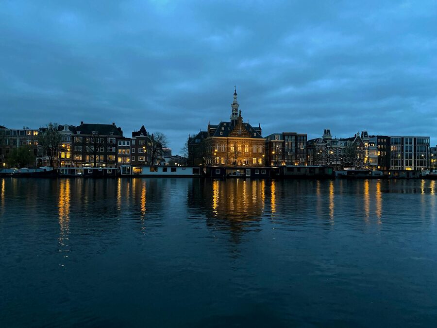 Amsterdam illuminated buildings waterfront evening
