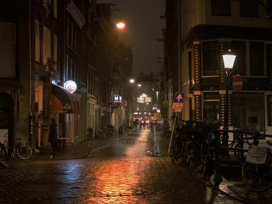 Dim Amsterdam old town alley near De Wallen at evening