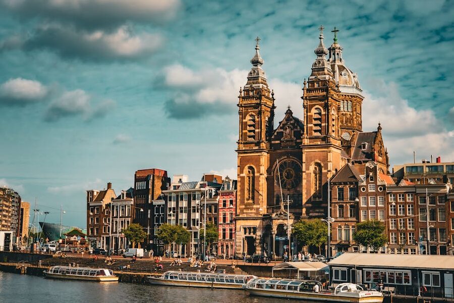 Amsterdam Basilica of St Nicholas with canal boats near Centraal Station
