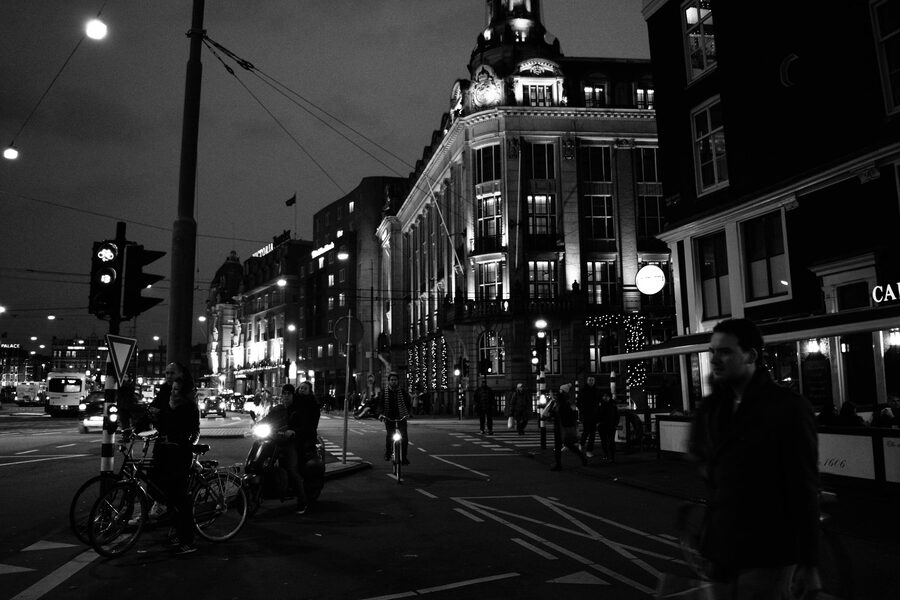 Black and white nighttime street scene central Amsterdam with bikes