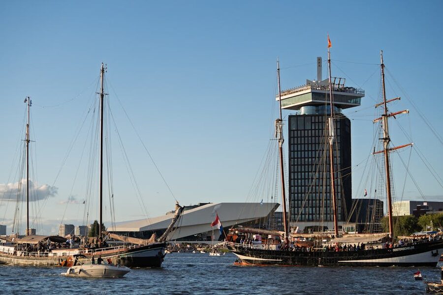 Tall ships in front of the ADAM Tower Amsterdam clear sky