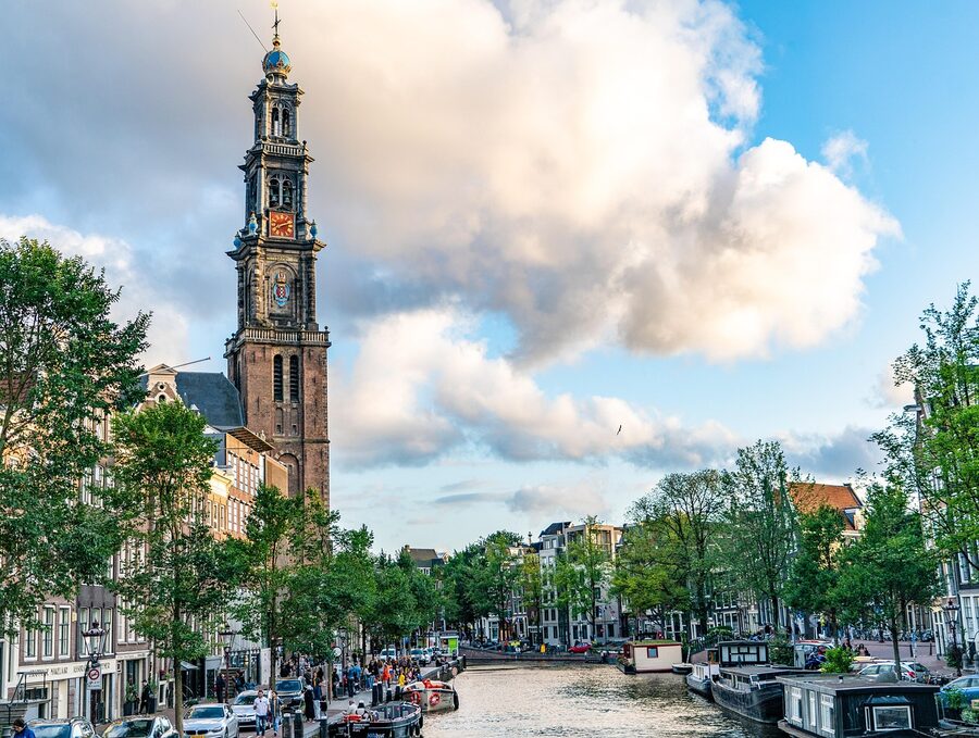 Westerkerk clock tower over the Amsterdam canal