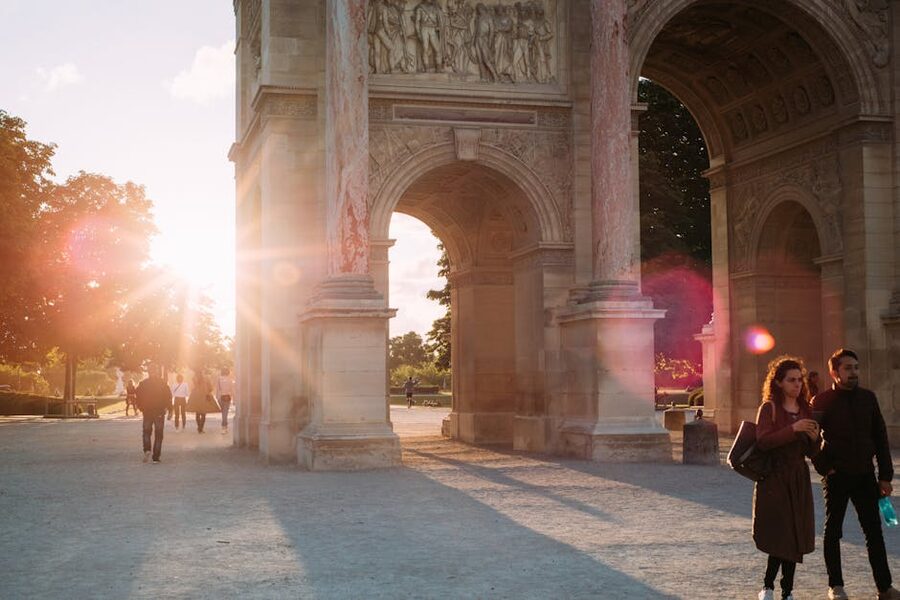 Sunrays through Arc de Triomphe archway Paris