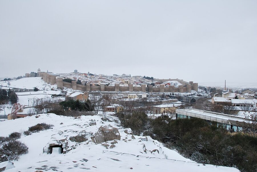 Walls of Avila in winter with light snow on the towers