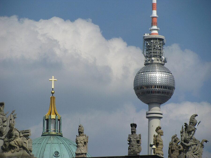 Cross reflection on Fernsehturm sphere with Berliner Dom in background