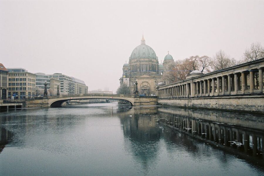 Berlin Cathedral seen behind a historic bridge over the Spree River