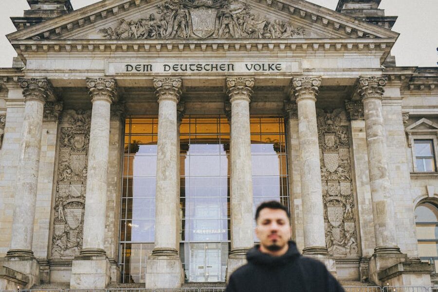 Tourist standing in front of the Reichstag building in Berlin