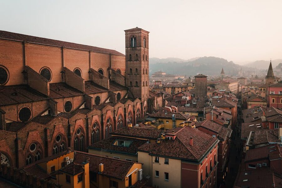 Aerial view of Bologna at dusk showing the red rooftops and historic centre