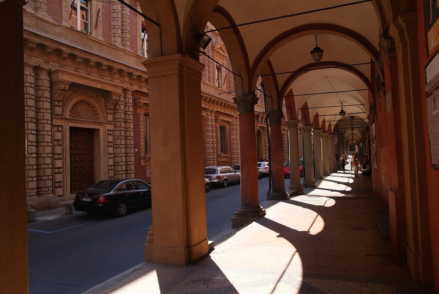 Long empty arcade walkway under the porticoes of Bologna