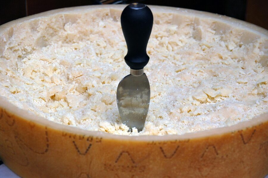 Wheels of Parmigiano-Reggiano cheese stamped with the consortium mark