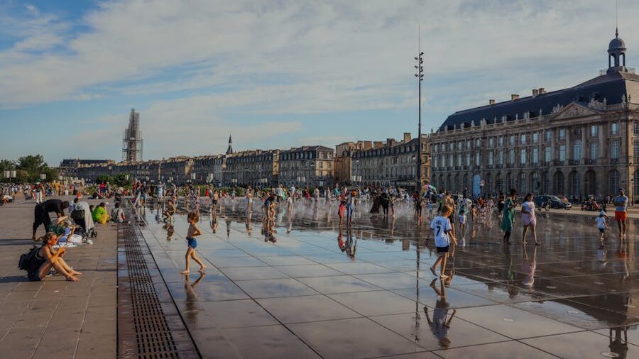 Children playing on the Miroir d Eau in summer Bordeaux