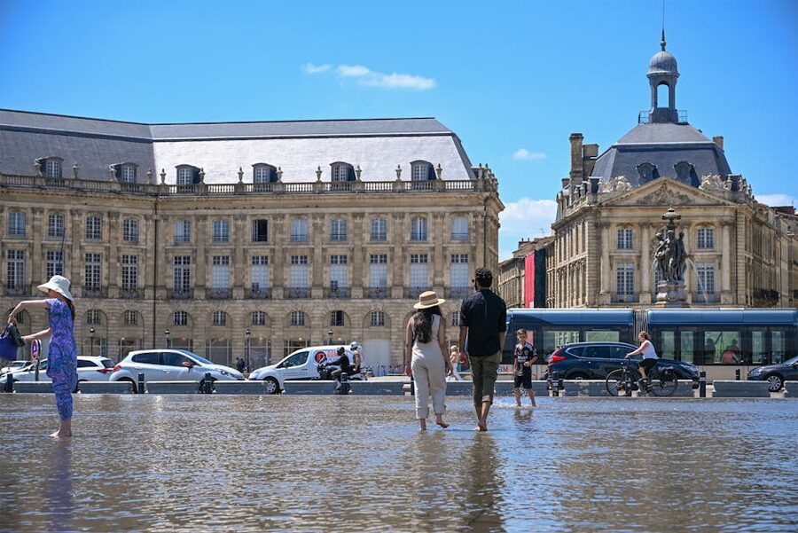 Tourists enjoying the Miroir d Eau Bordeaux water mirror
